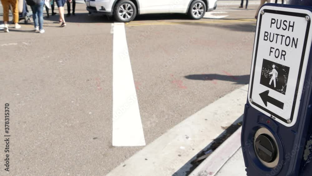 Traffic light button on pedestrian crosswalk, people have to push and