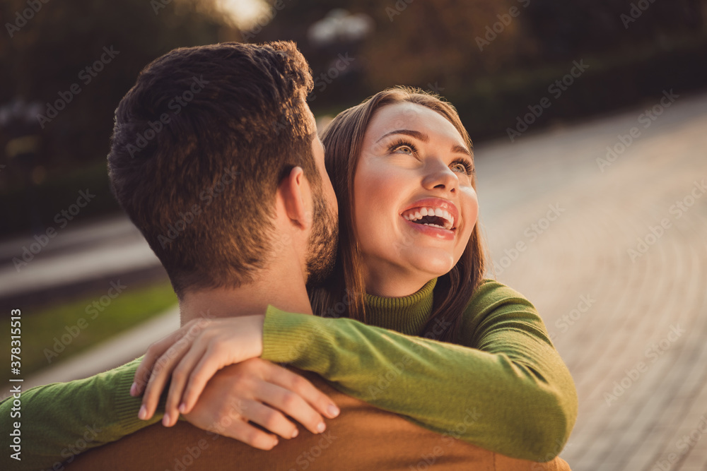 Fototapeta premium Back rear spine view portrait of passionate bonding girl hug boyfriend in autumn october park wear turtleneck jumper