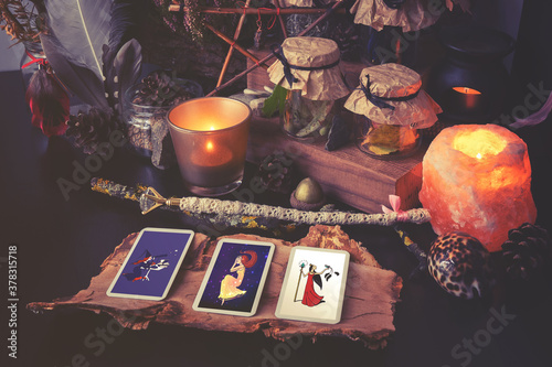 Photography 3 Tarot cards spread lying on a black table with magic items