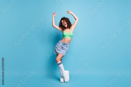 Fototapeta Naklejka Na Ścianę i Meble -  Full size photo of carefree crazy lady model scream loud music hands air party clubber hang out youngster activities advert wear green top jeans skirt isolated pastel blue color background
