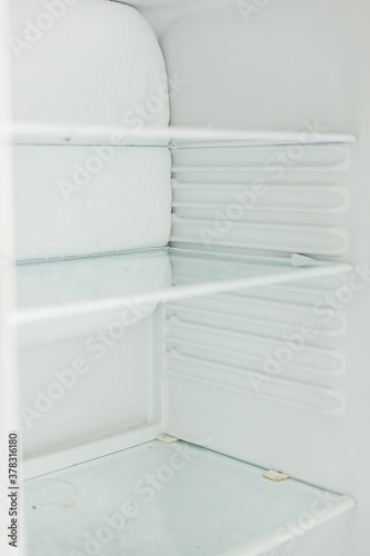 Broken fridge. defrosted refrigerator. Open freezer © olenachukhil