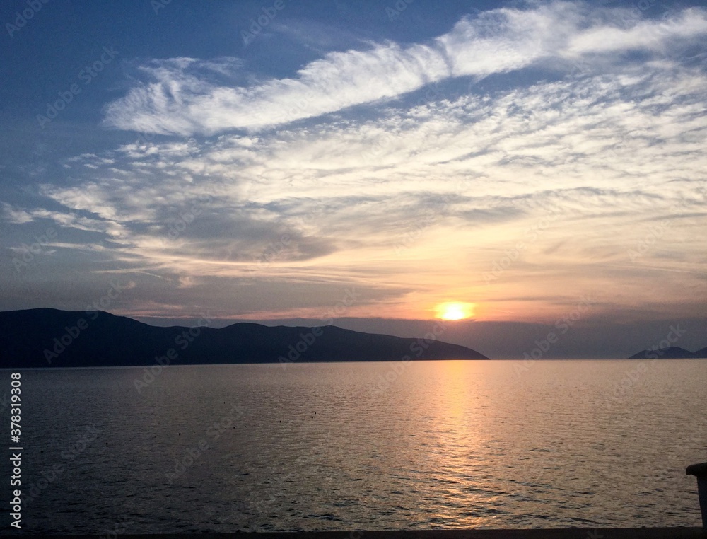 sunset over the sea with light with light cirrus clouds sunset over the sea with light with light cirrus clouds