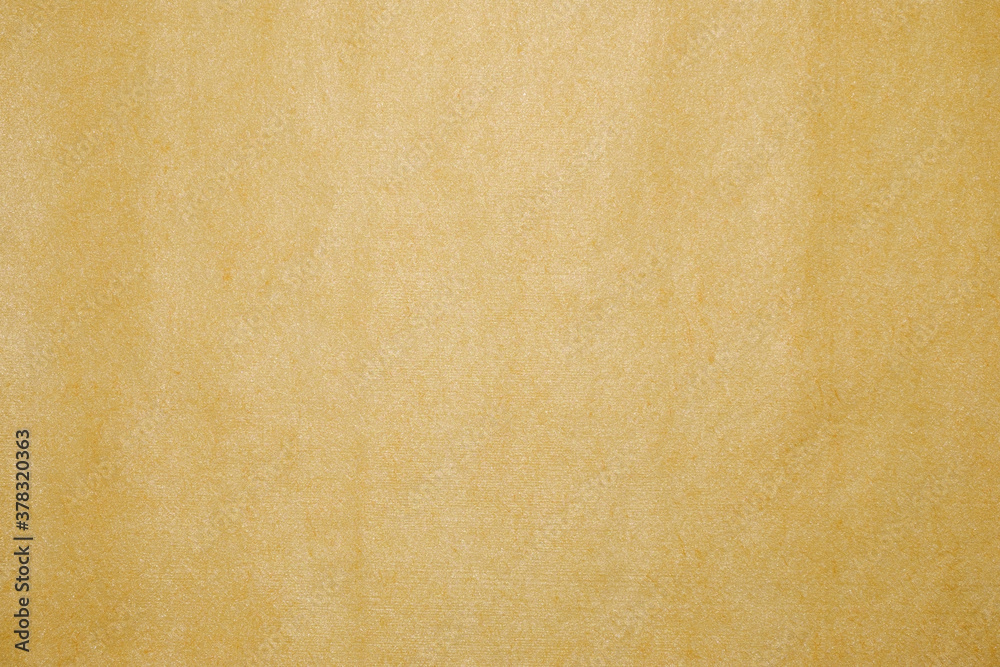The texture of a yellow-gold disposable textile towel. The texture of a yellow-gold disposable textile towel.