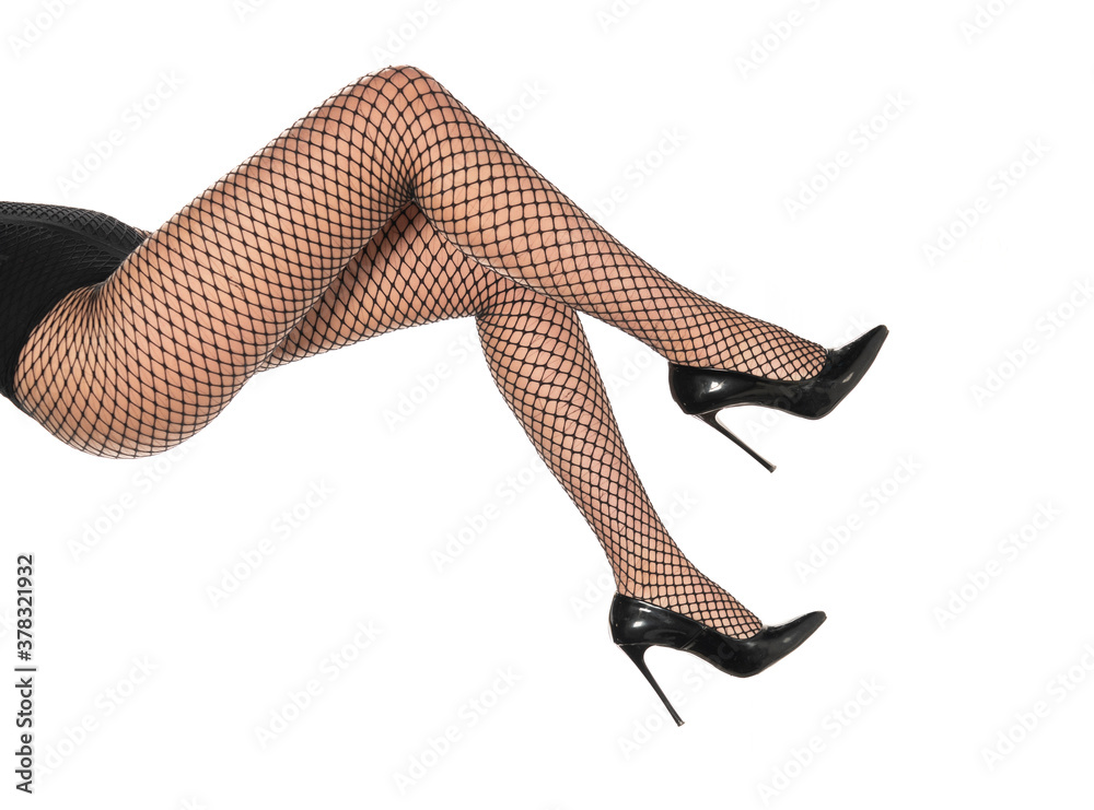 pretty female legs in fishnet stockings and black high heels - obrazy, fototapety, plakaty 