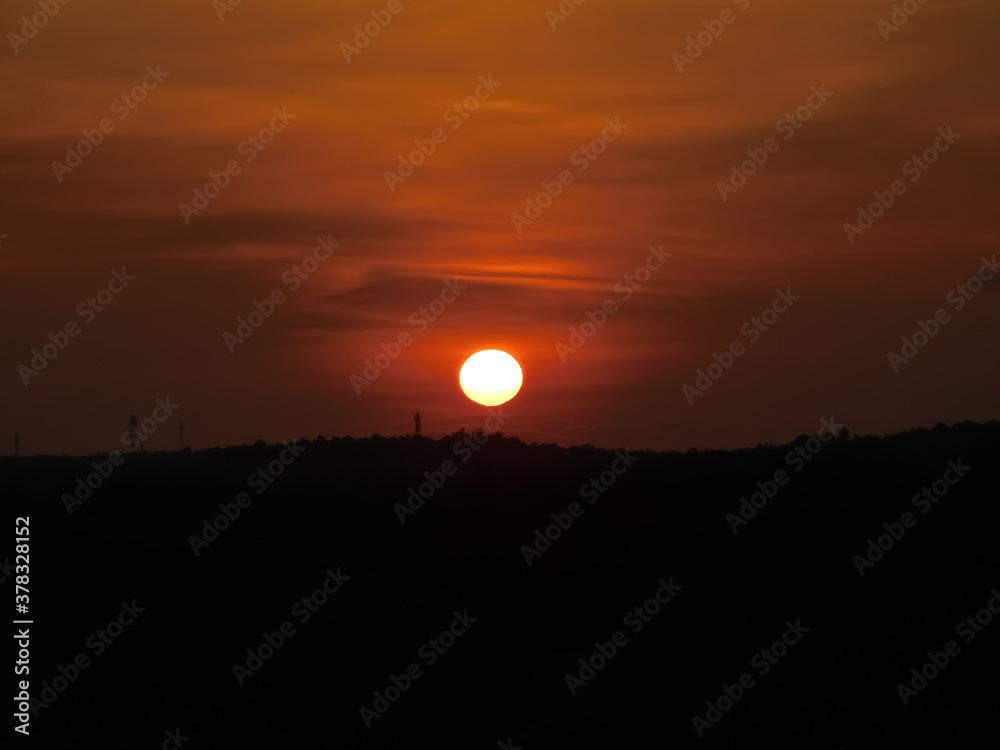 Fototapeta premium View of sunset over the dark plants