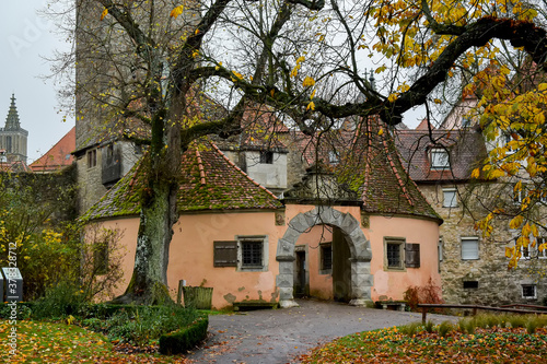 View on medieval castle gate from park Burggarten in old town Rothenburg ob der Tauber, Bavaria, Germany. November 2014