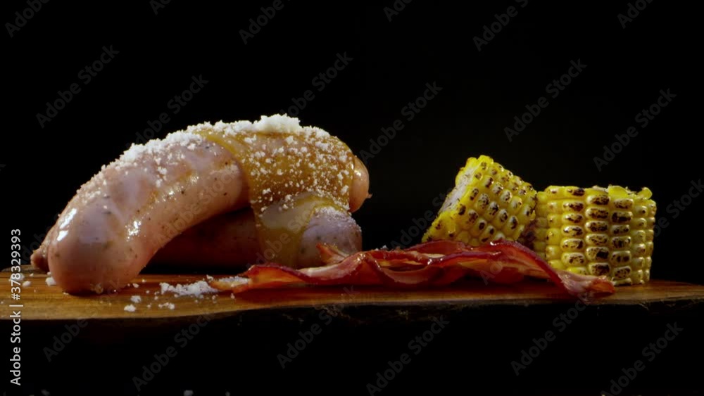 Smooth zoom in on tasty and appetizing sausages and sausages with a macro lens. Advertising frame of a meat factory on a black background in a professional studio. Foodstyle concept. High quality 4k Smooth zoom in on tasty and appetizing sausages and sausages with a macro lens. Advertising frame of a meat factory on a black background in a professional studio. Foodstyle concept. High quality 4k