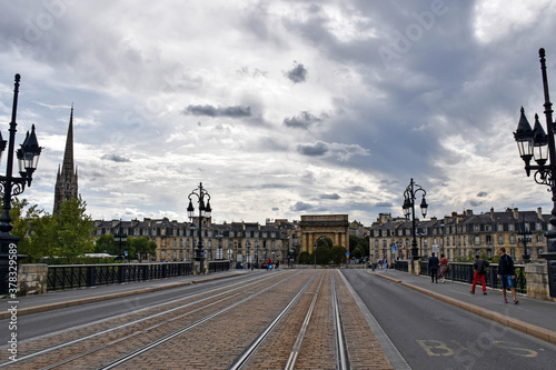 Street with tram tracks in perspective and city in the background 