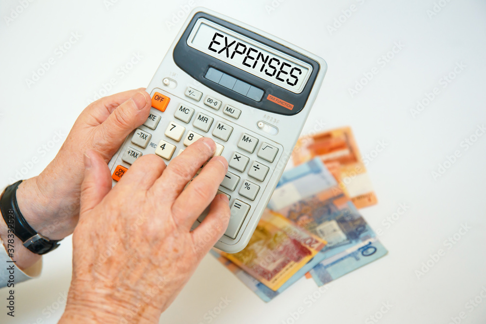 An elderly woman holds a calculator in her hands and calculates expenses. An elderly woman holds a calculator in her hands and calculates expenses.