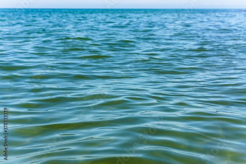 Smooth green water. Clear water surface. Background water.