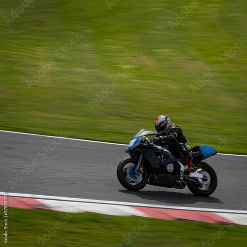A panning shot of a racing bike as it circuits a track. © SnapstitchPhoto