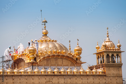 Amritsar, India - AUGUST 15: Cleaning service on the cupola of Golden Temple (Harmandir Sahib) on August 15, 2016 in Amritsar, Panjab, India.