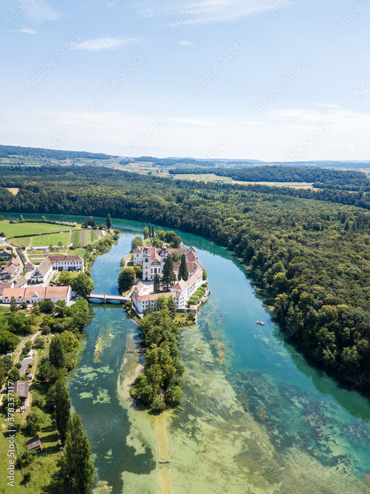 Aerial view by drone over the Rheinau Abbey Islet on Rhine river, Switzerland