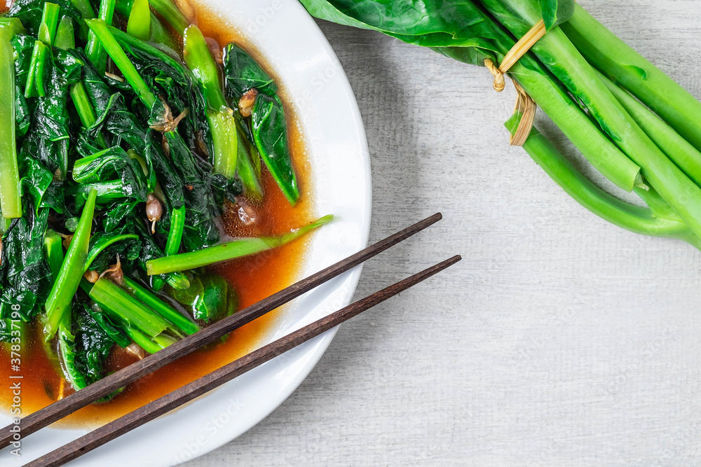 Fried Kale with Oyster Sauce menu on wooden table Fried Kale with Oyster Sauce menu on wooden table