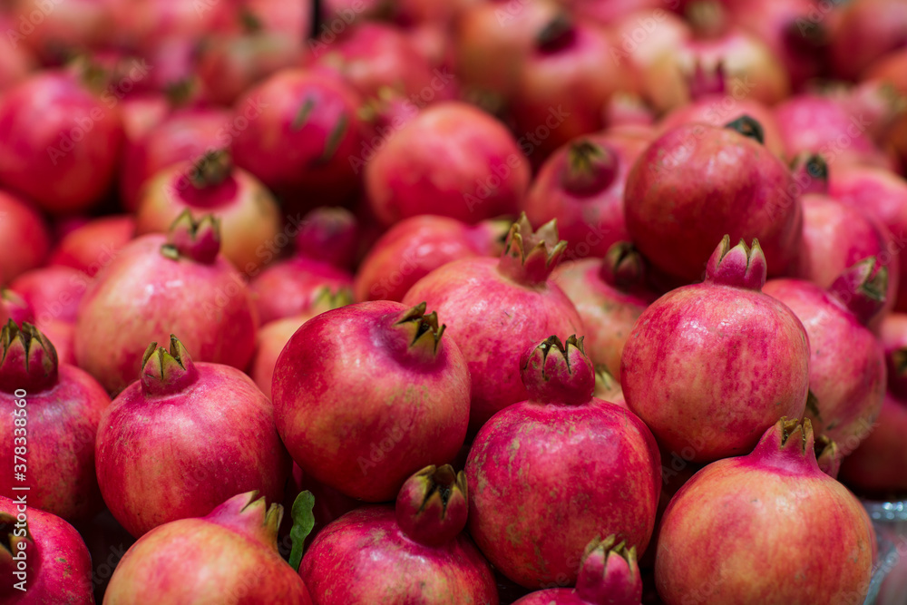 Juicy and tasty pomegranate fruit background. Pile of fresh ripe pomegranates.
Juicy and tasty pomegranate fruit background. Pile of fresh ripe pomegranates.