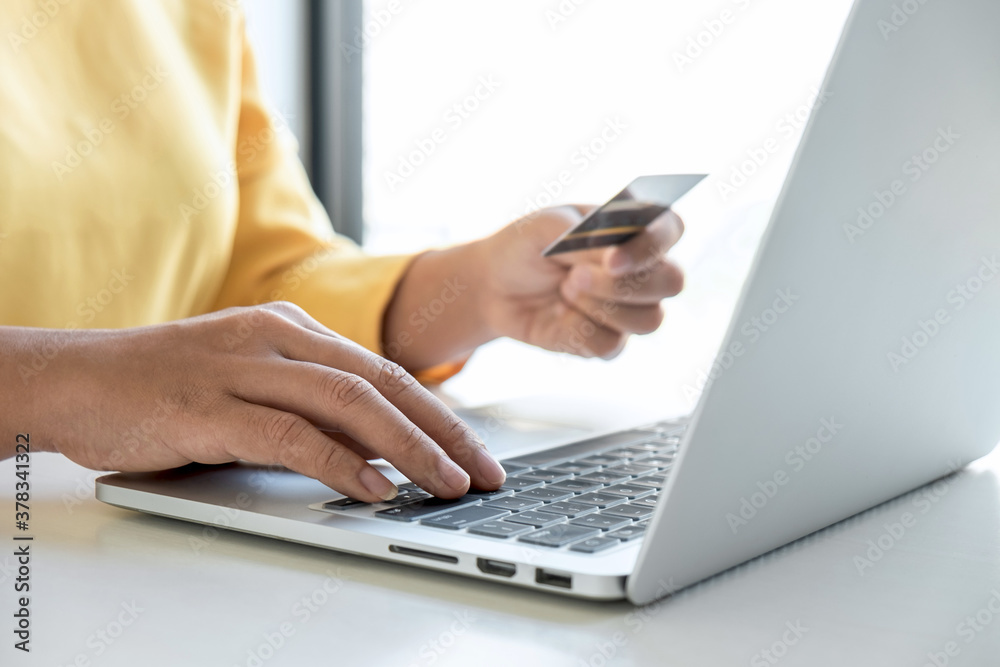 Fototapeta premium Woman using credit card register security code payments online shopping and customer service network connection market, using technology on laptop, Internet Online shopping or banking concept