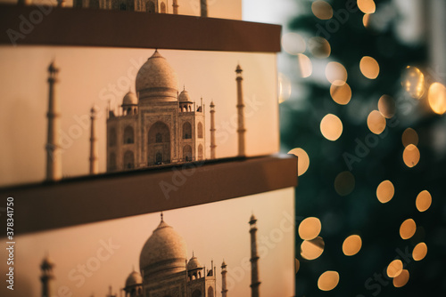 Photography Closeup of stacked boxes printed with the Taj Majal mausoleum and bokeh lights i