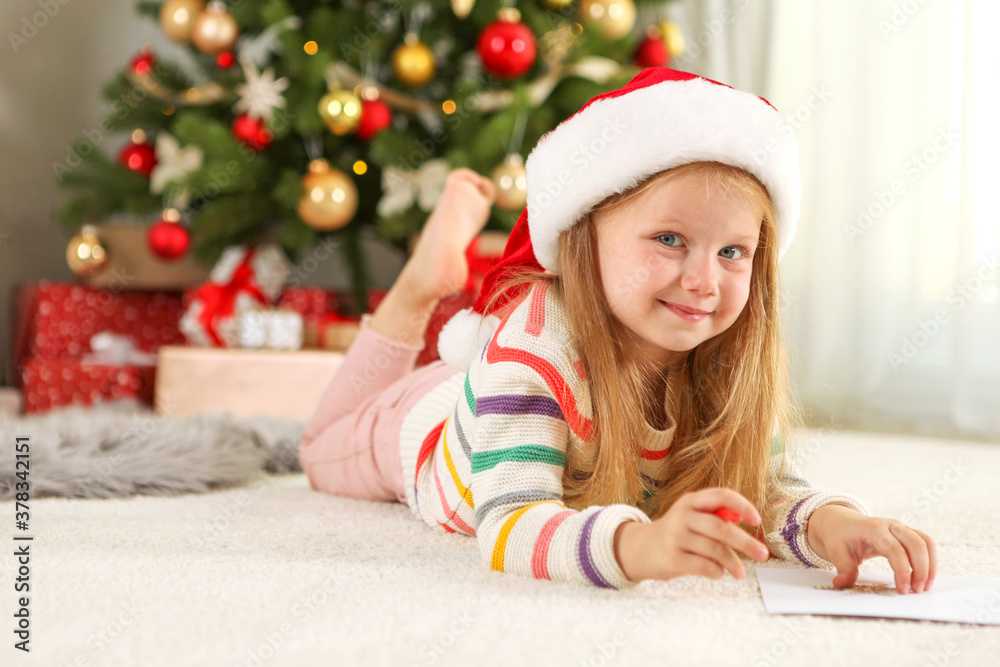 Little girl in Christmas interior writes a letter to Santa Claus
Little girl in Christmas interior writes a letter to Santa Claus