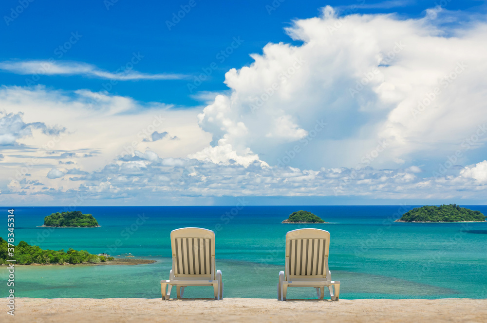 Couple of beach beds on tropical beach with beautyful blue sky