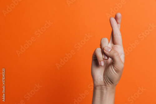 Close up of woman's fingers showing crossed fingers