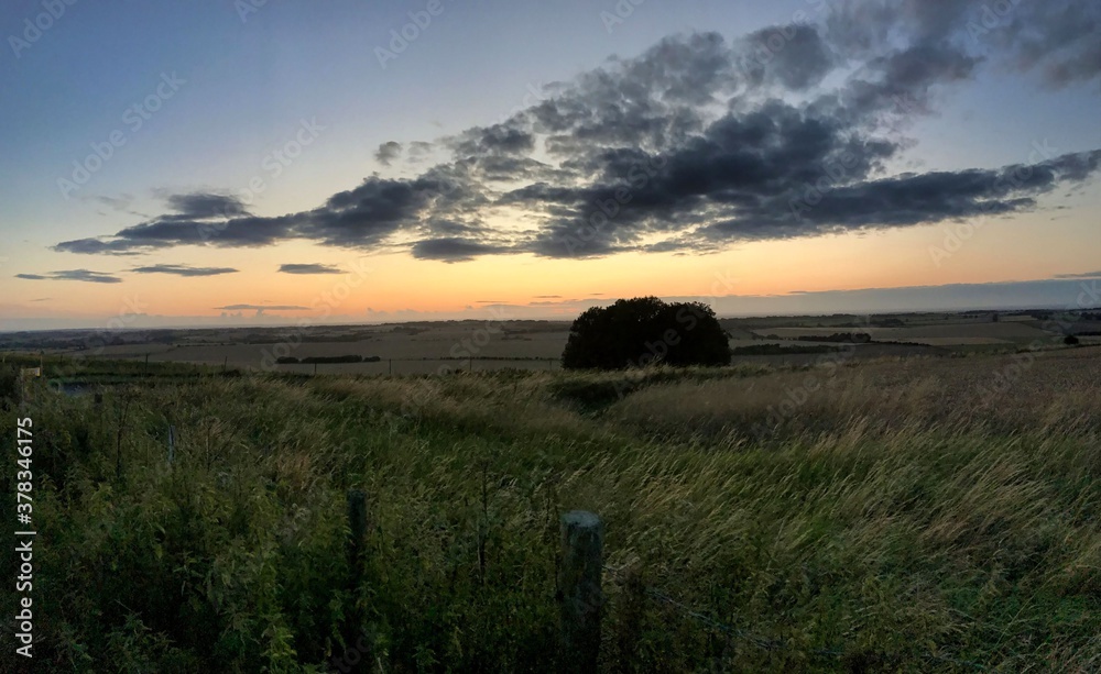 Fototapeta premium landscape at sunset at avesbury hill england