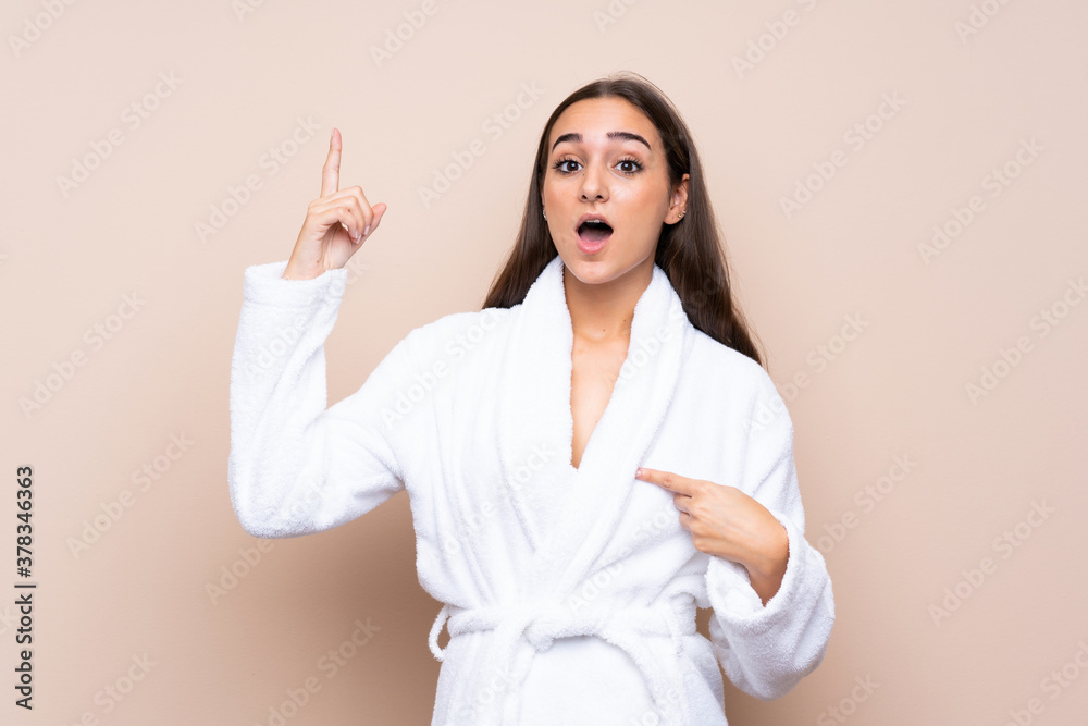 Young girl in a bathrobe over isolated background with surprise facial expression Young girl in a bathrobe over isolated background with surprise facial expression