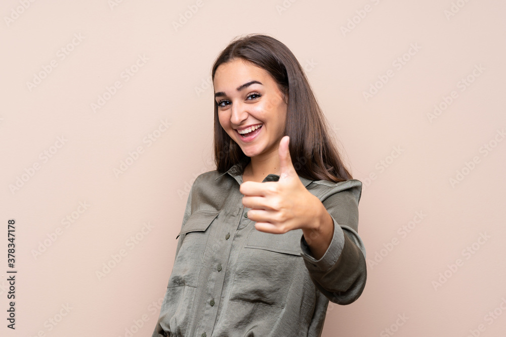 Young girl over isolated background with thumbs up because something good has happened