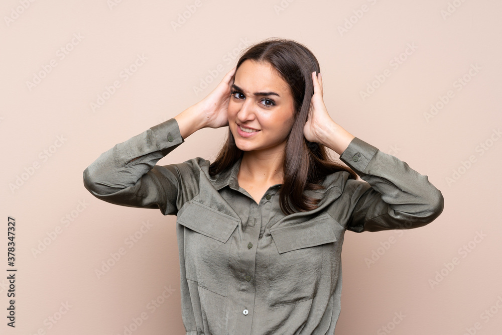 Young girl over isolated background frustrated and takes hands on head Young girl over isolated background frustrated and takes hands on head