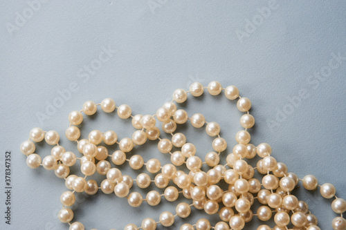 Pearl beads on a gray background decoration decoration top view
