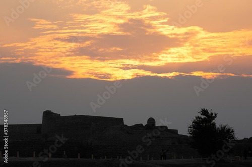 Ancient Bahrain Fort and dramatic clouds during sunset, Bahrain photo