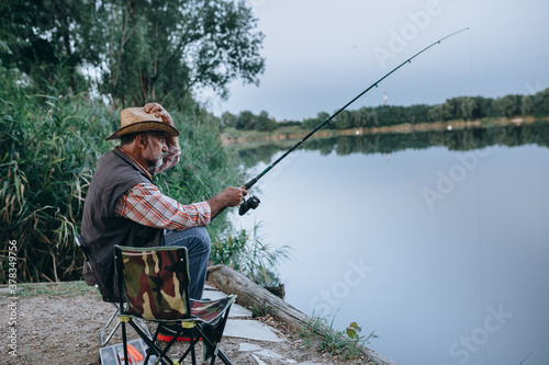 middle aged man fishing on the lake