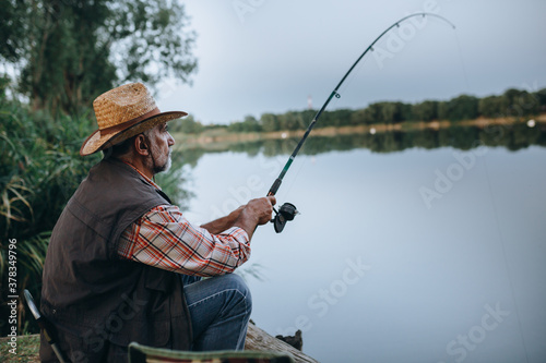 middle aged man fishing on the lake