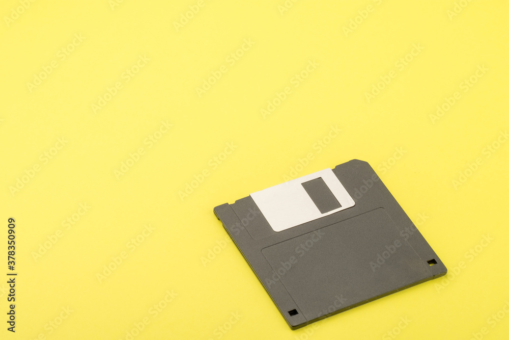 floppy disk on a yellow paper background floppy disk on a yellow paper background