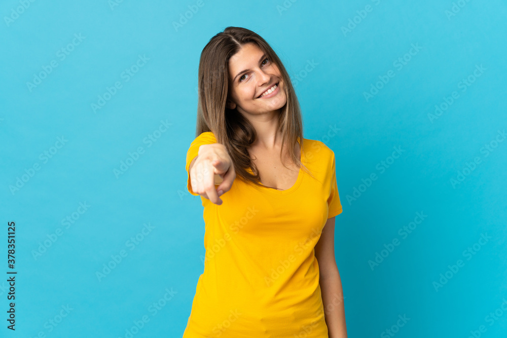 Young slovak woman isolated on blue background pointing front with happy expression Young slovak woman isolated on blue background pointing front with happy expression