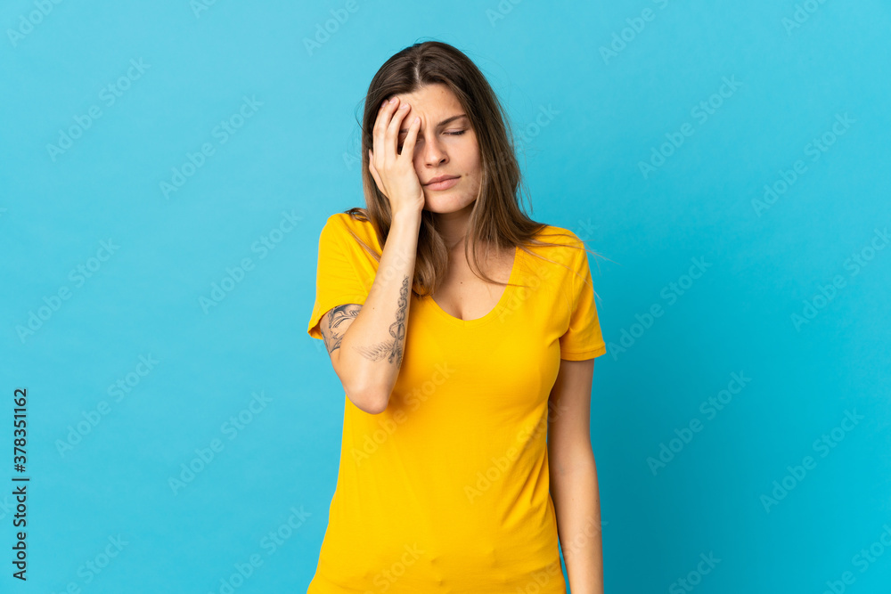 Young slovak woman isolated on blue background with headache Young slovak woman isolated on blue background with headache