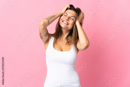 Young slovak woman isolated on pink background laughing