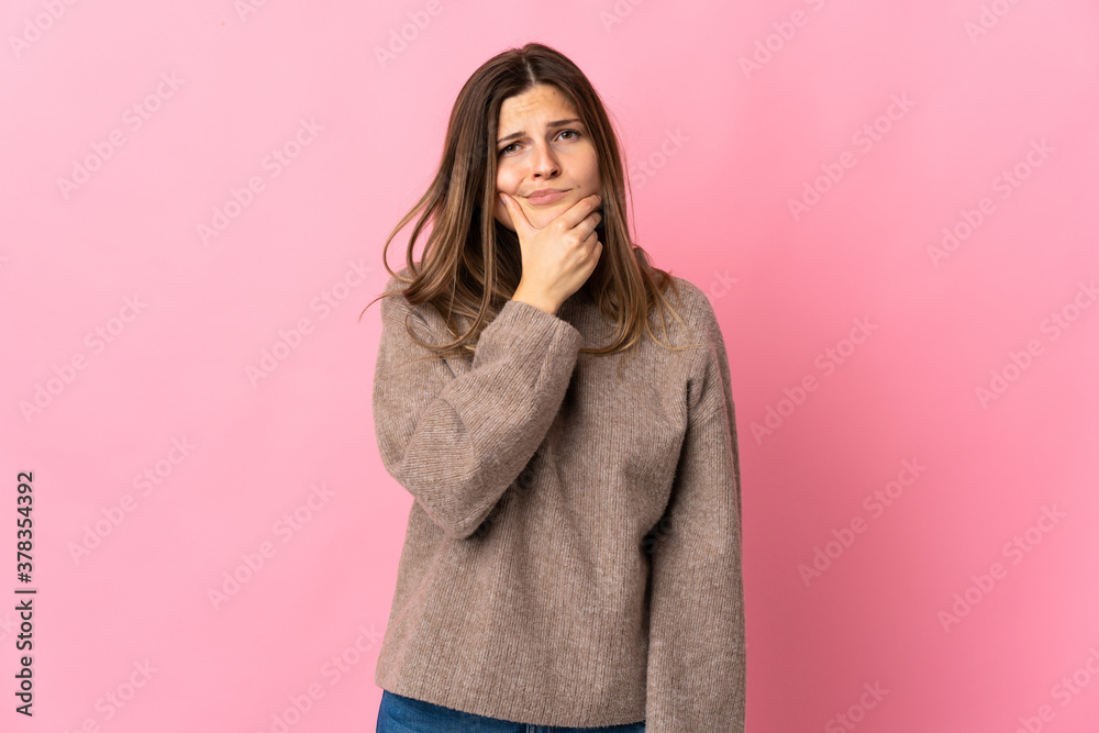 Young slovak woman isolated on pink background having doubts Young slovak woman isolated on pink background having doubts