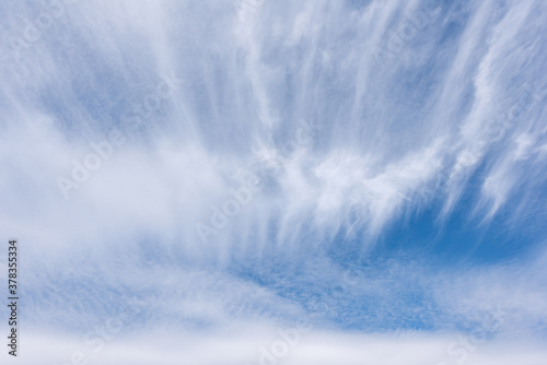 Long white wisps of clouds flowing with a large rippled cloud, Beautiful cloud in blue sky