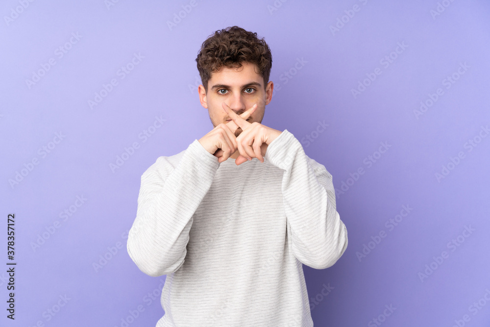 Caucasian man isolated on purple background showing a sign of silence gesture Caucasian man isolated on purple background showing a sign of silence gesture