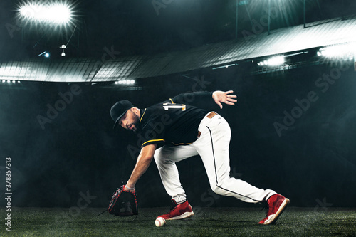 Porfessional baseball player with ball on grand arena. Ballplayer on stadium in action.