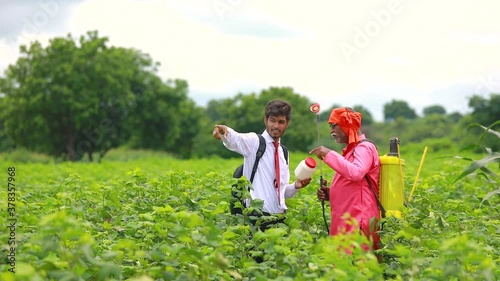indian farmer with salesman at field