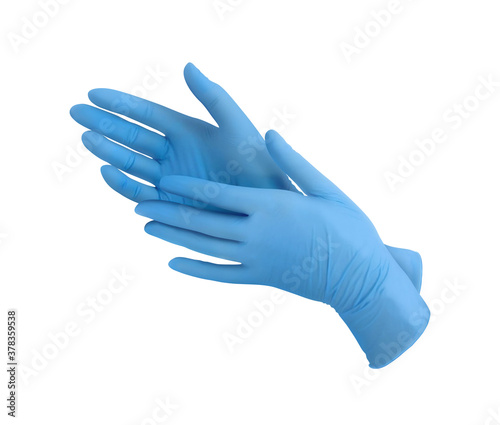 Medical nitrile gloves.Two blue surgical gloves isolated on white background with hands. Rubber glove manufacturing, human hand is wearing a latex glove. Doctor or nurse putting on protective gloves photo
