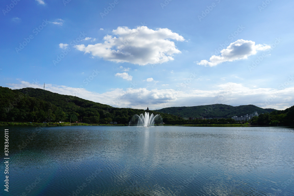 Fountain in the lake under the blue sky