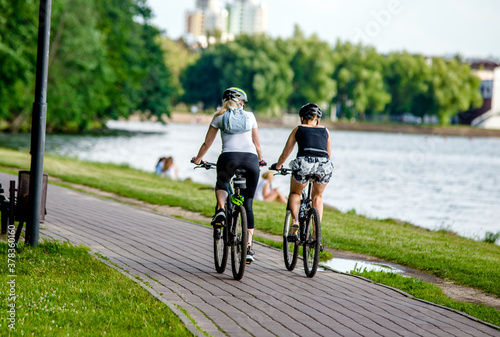 Fototapeta Naklejka Na Ścianę i Meble -  Cyclists ride on the bike path in the city Park
