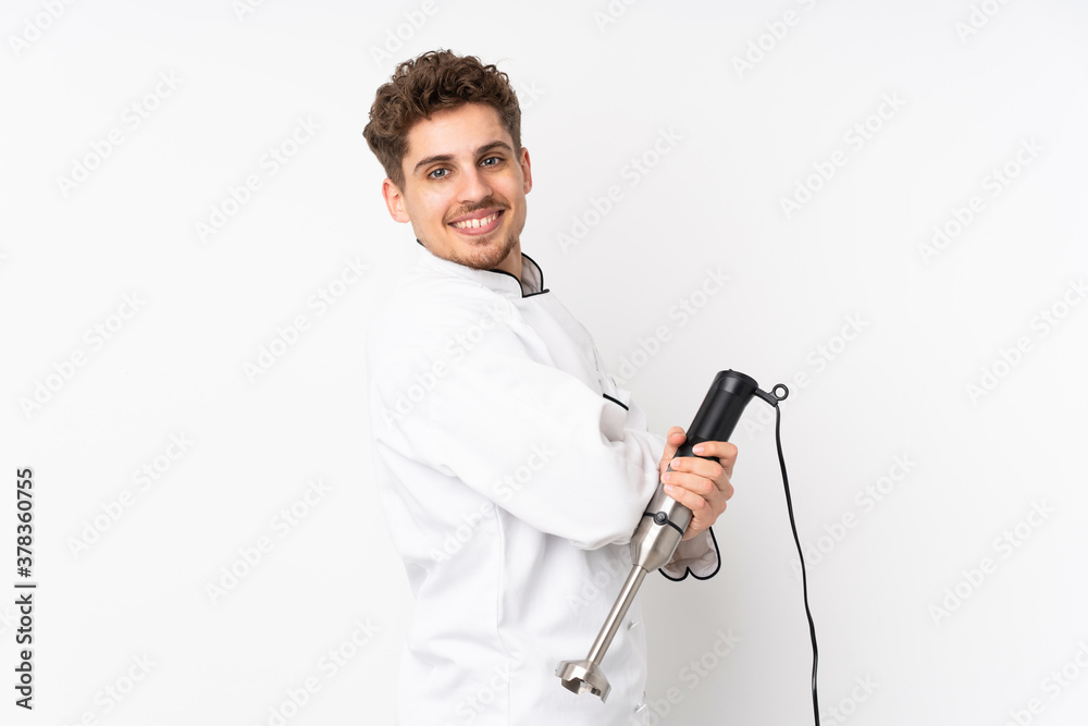 Man using hand blender isolated on white background laughing Man using hand blender isolated on white background laughing
