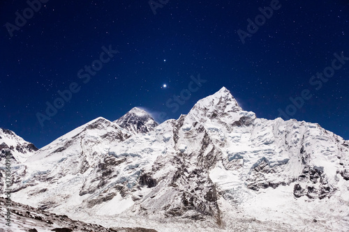 Mount Everest under bright stars. Everest base camp on clear starry night. View from the trail to Kala Patthar. Himalayas. Nepal. © Eugene Ga