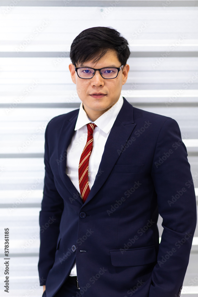 Portrait of young Asian businessman look at camera. Successful business man standing wearing suit on white background . Portrait of young Asian businessman look at camera. Successful business man standing wearing suit on white background .