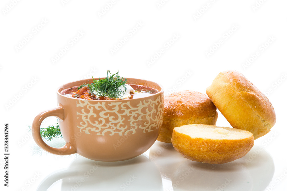 hot beetroot soup with sour cream, herbs and rolls in a ceramic bowl hot beetroot soup with sour cream, herbs and rolls in a ceramic bowl