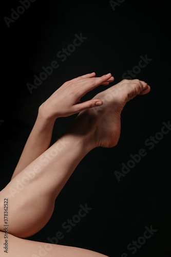 Smooth female legs on a black background