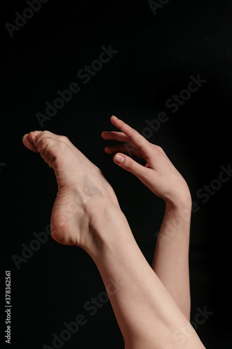 Smooth female legs on a black background © Alexander Y